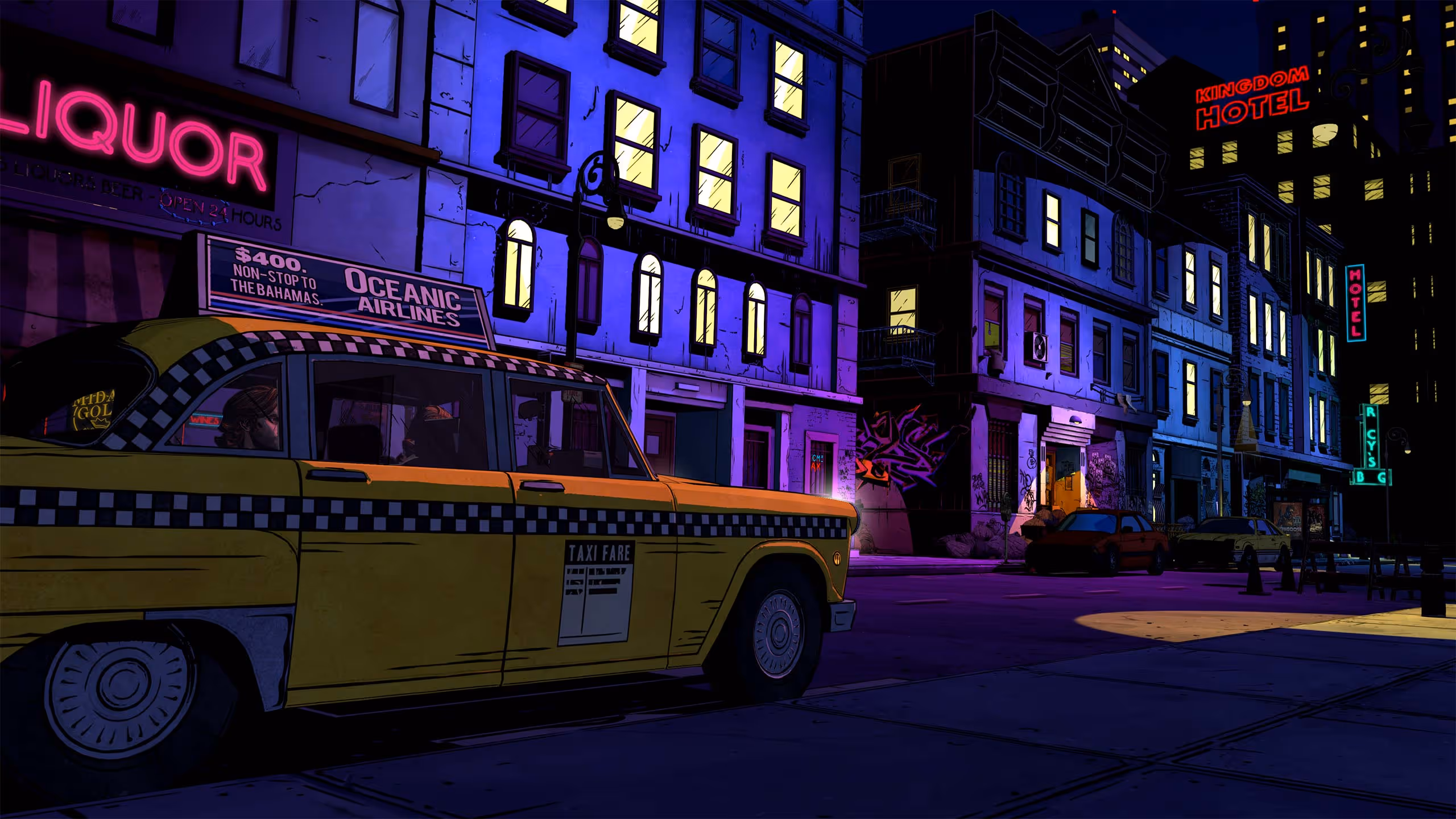 A yellow taxi passes illuminated Fabletown storefronts at night.