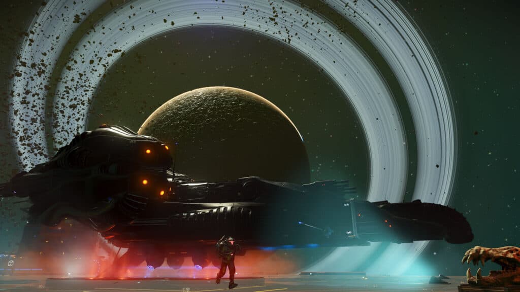 A figure stands beside a dark ship beneath a large ringed planet.